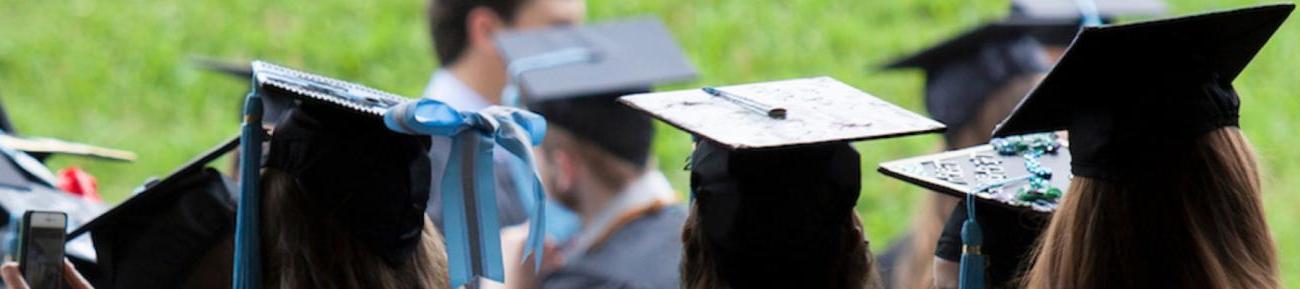 Students at graduation with cap and gown on.